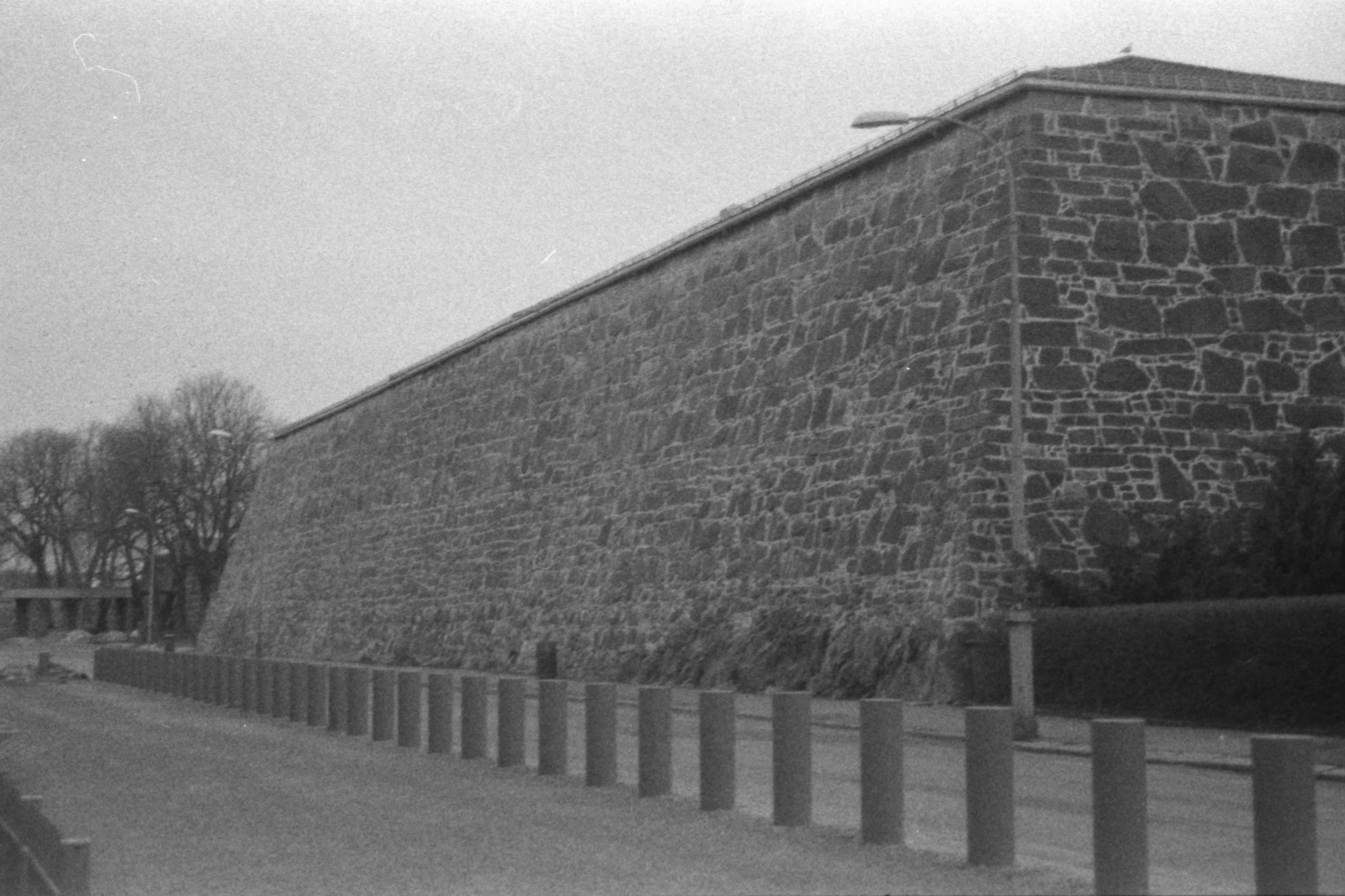 Black and white picture of a large, wall-like building