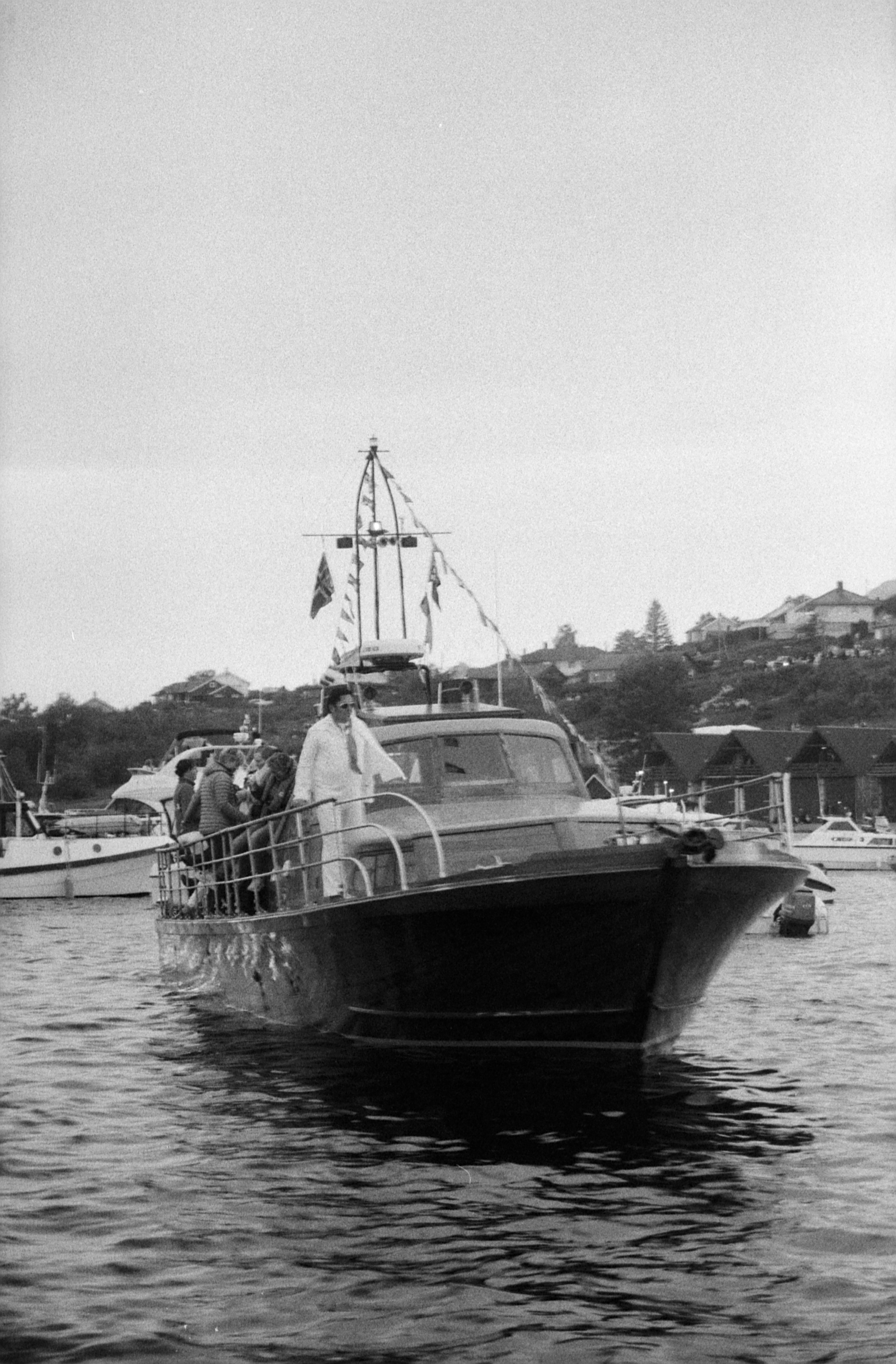 Black and white picture of a boat with an Elvis impersonator on it
