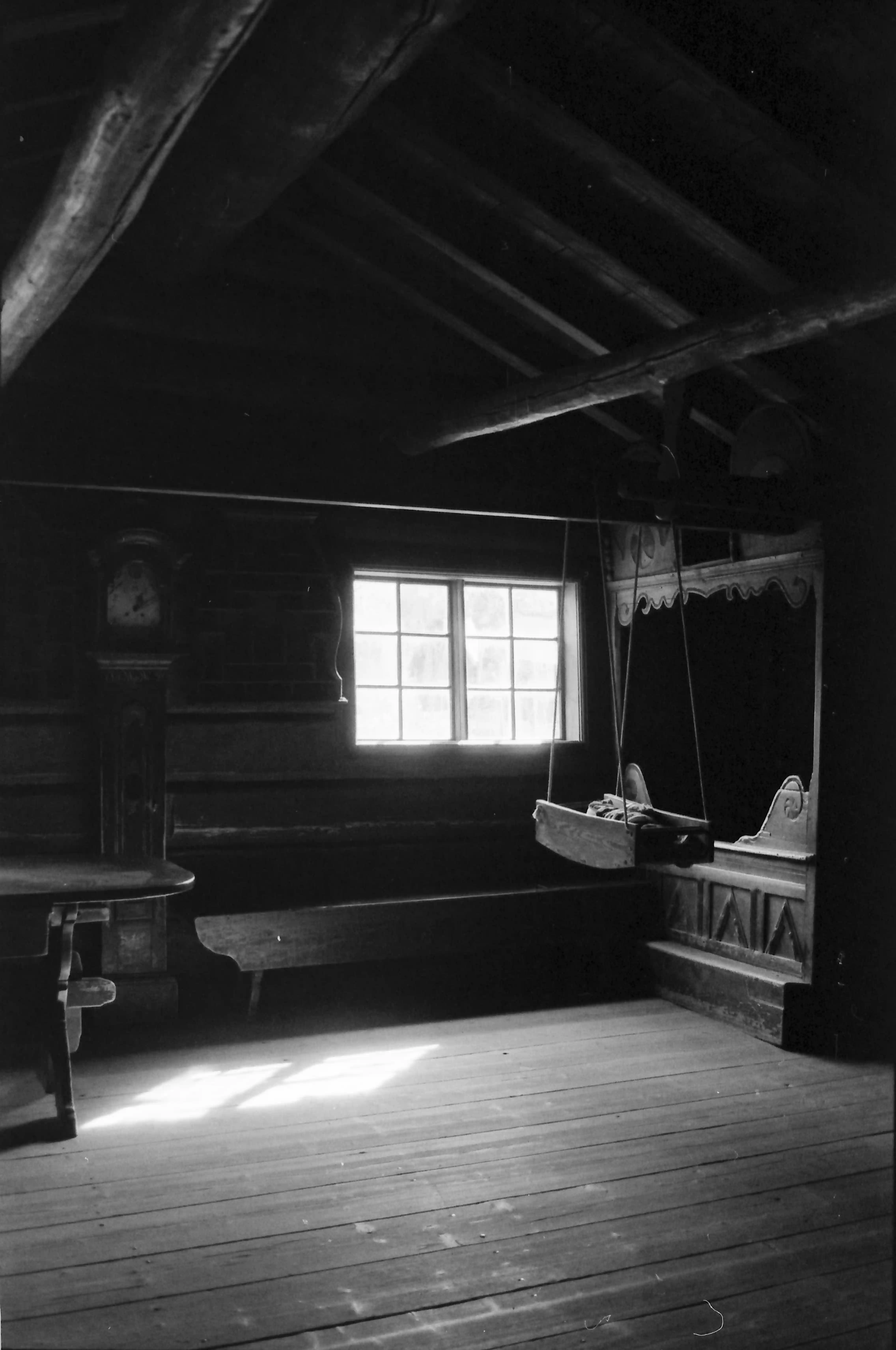 Black and white picture of the interior of a very old Norwegian wooden house